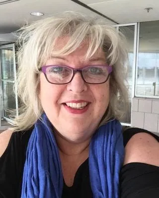 Warm portrait of trauma-informed coach in a calming space