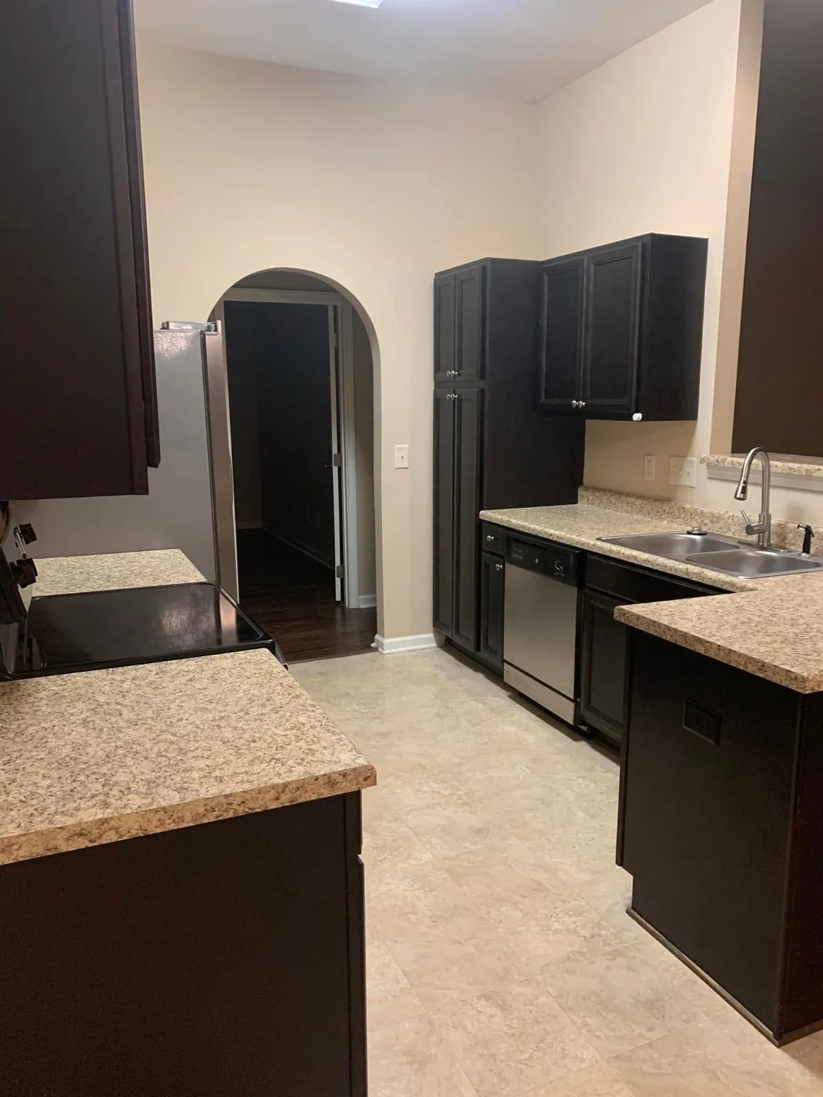 Dark-cabinet kitchen with granite counters cleaned by Pretty in Pink Cleaning Service near Millbrook, AL