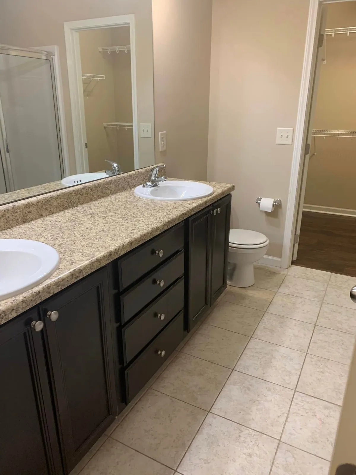 Double vanity with dark cabinets in a bathroom cleaned by Pretty in Pink Cleaning Service near Montgomery, AL