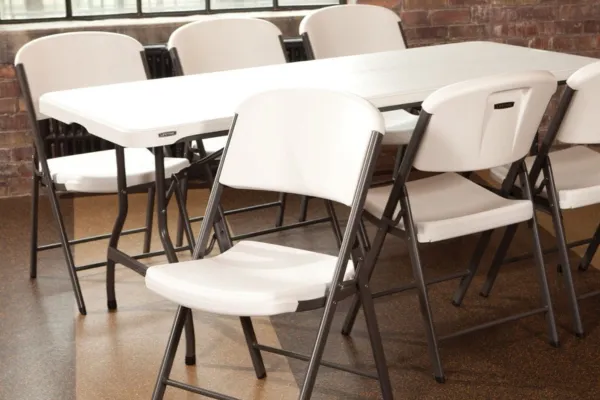 Fancy Fiesta rectangle table with white folding chairs available for event rentals in Midland, TX