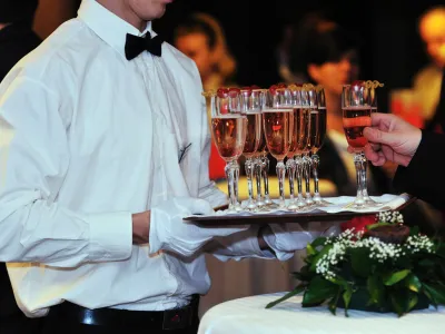 Fancy Fiesta event services for holiday parties, with professional waitstaff serving champagne in Midland, TX