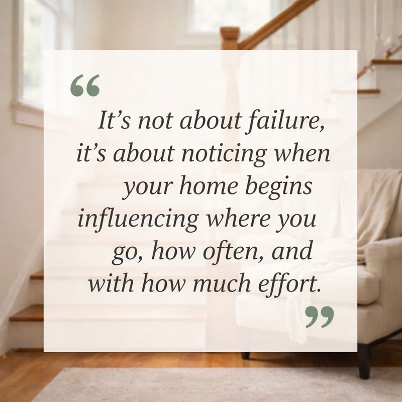 Softly lit interior staircase with wooden steps and railing, a cozy upholstered chair at the base, and natural light from a window, evoking comfort, reflection, and ease of movement in the home.