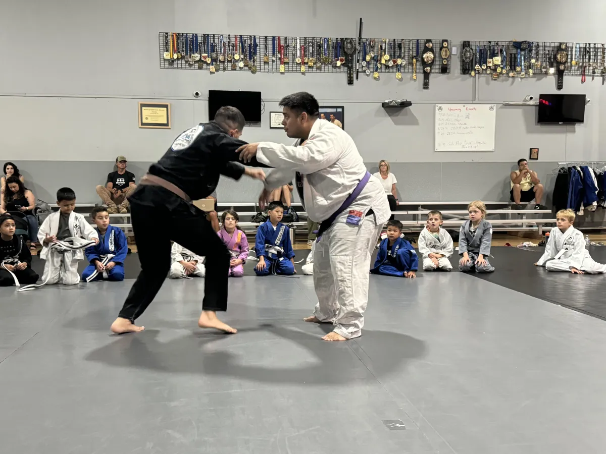 Kids learning Jiu-Jitsu with black belt instructors