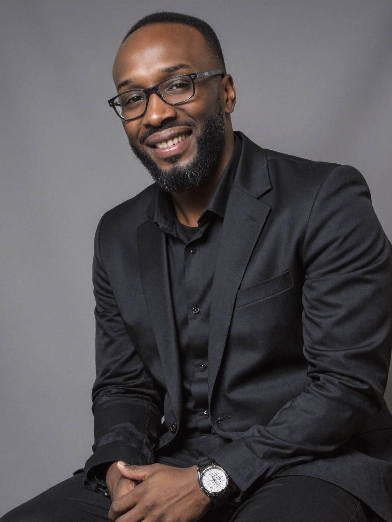 a kitchen with three stools and a center island