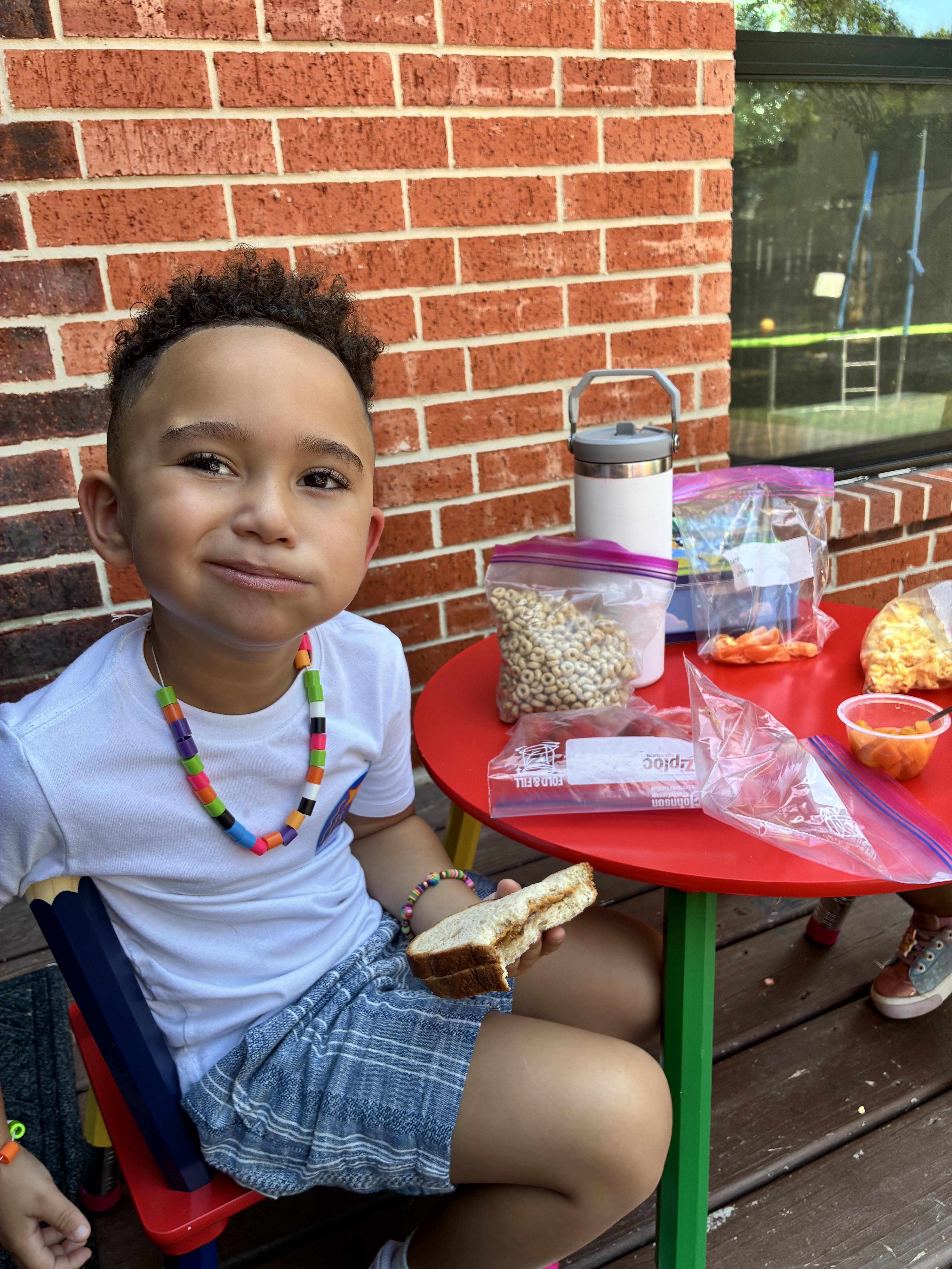 Child waves at laptop