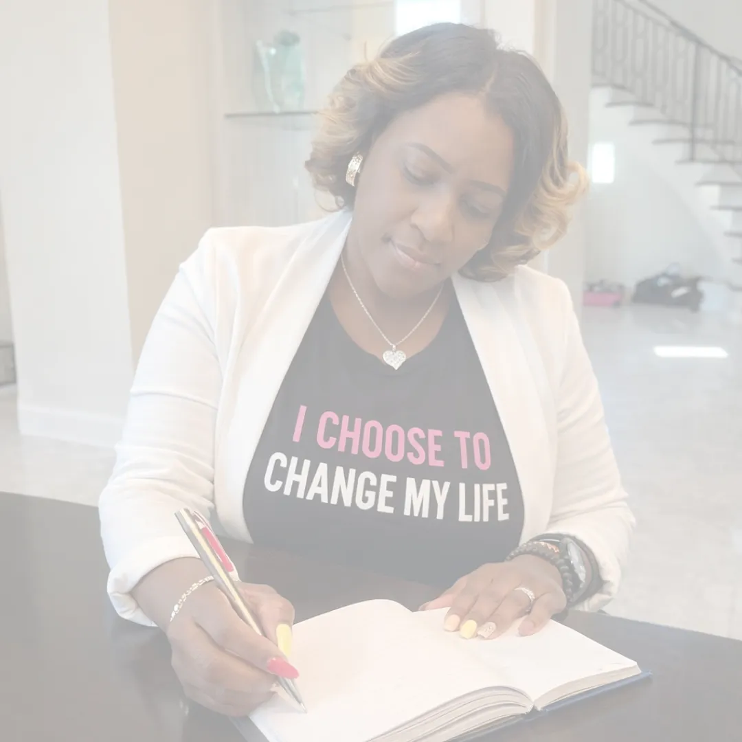 Woman sitting quietly with a warm drink, pausing in a calm, soft-lit space