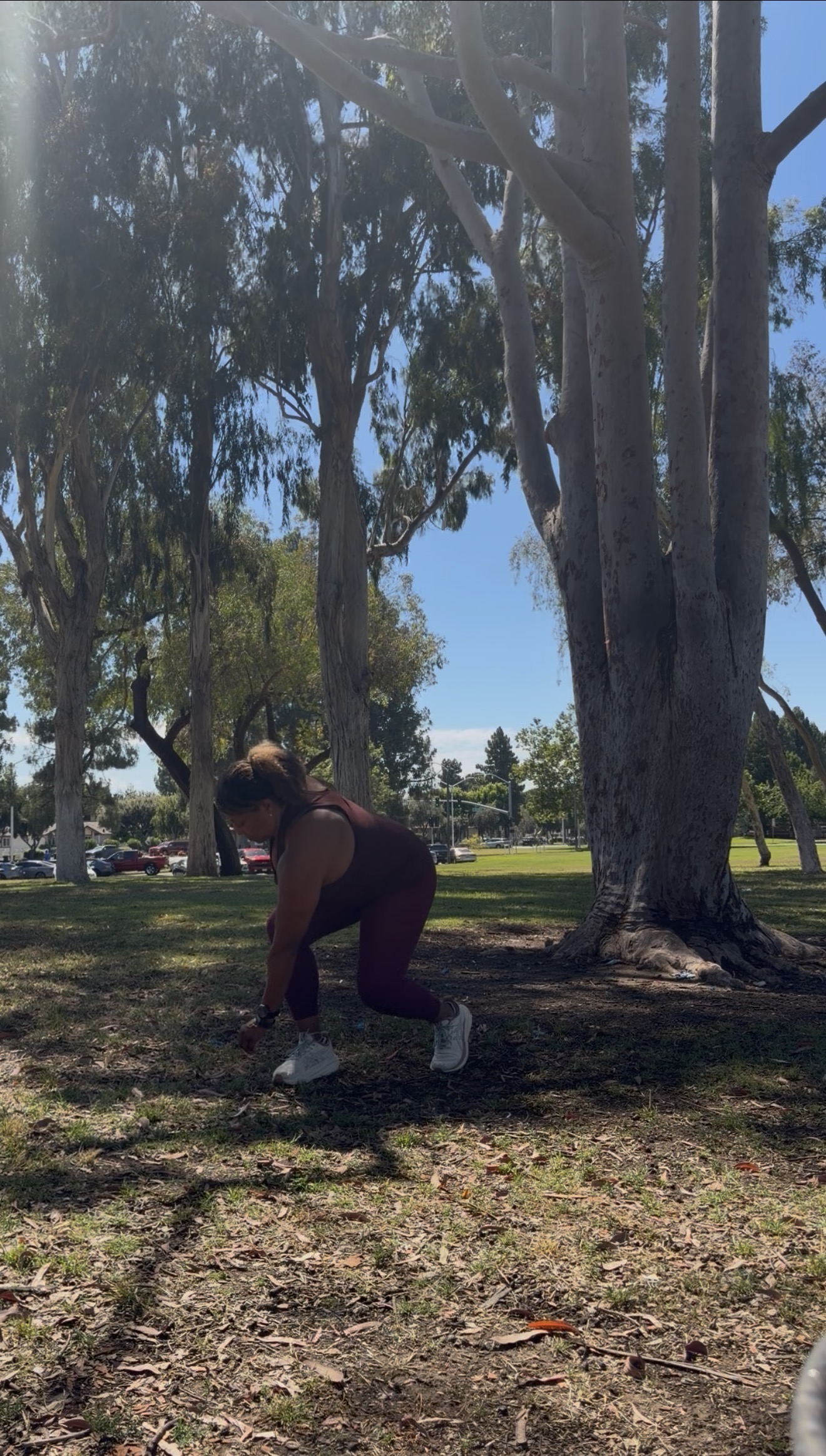 Thumbnail of a woman performing a reverse lunge outdoors.
