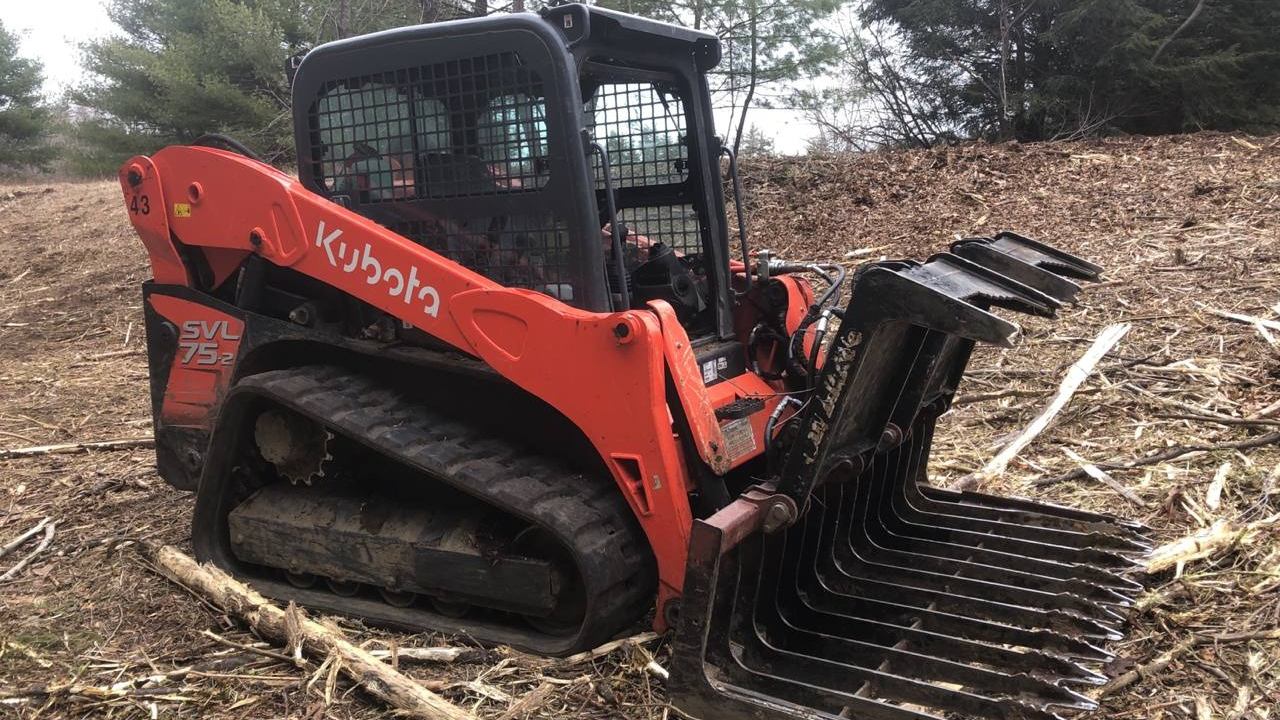 A tractor parked in the middle of a forest