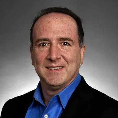 person using microsoft surface laptop on lap with two other people