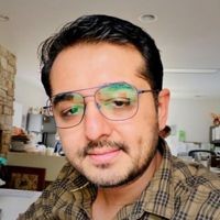 four people watching on white MacBook on top of glass-top table