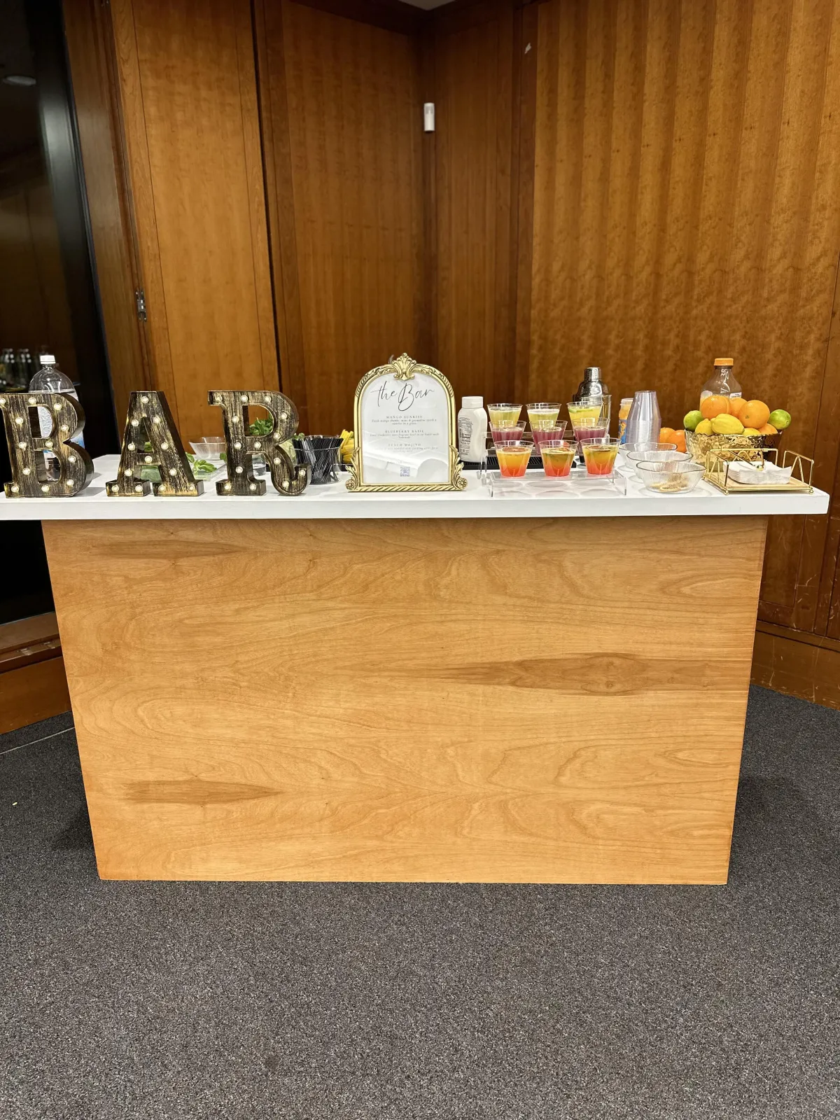 Elegant mobile mocktail bar setup for a corporate event in New York City with signature drinks and branded decor.