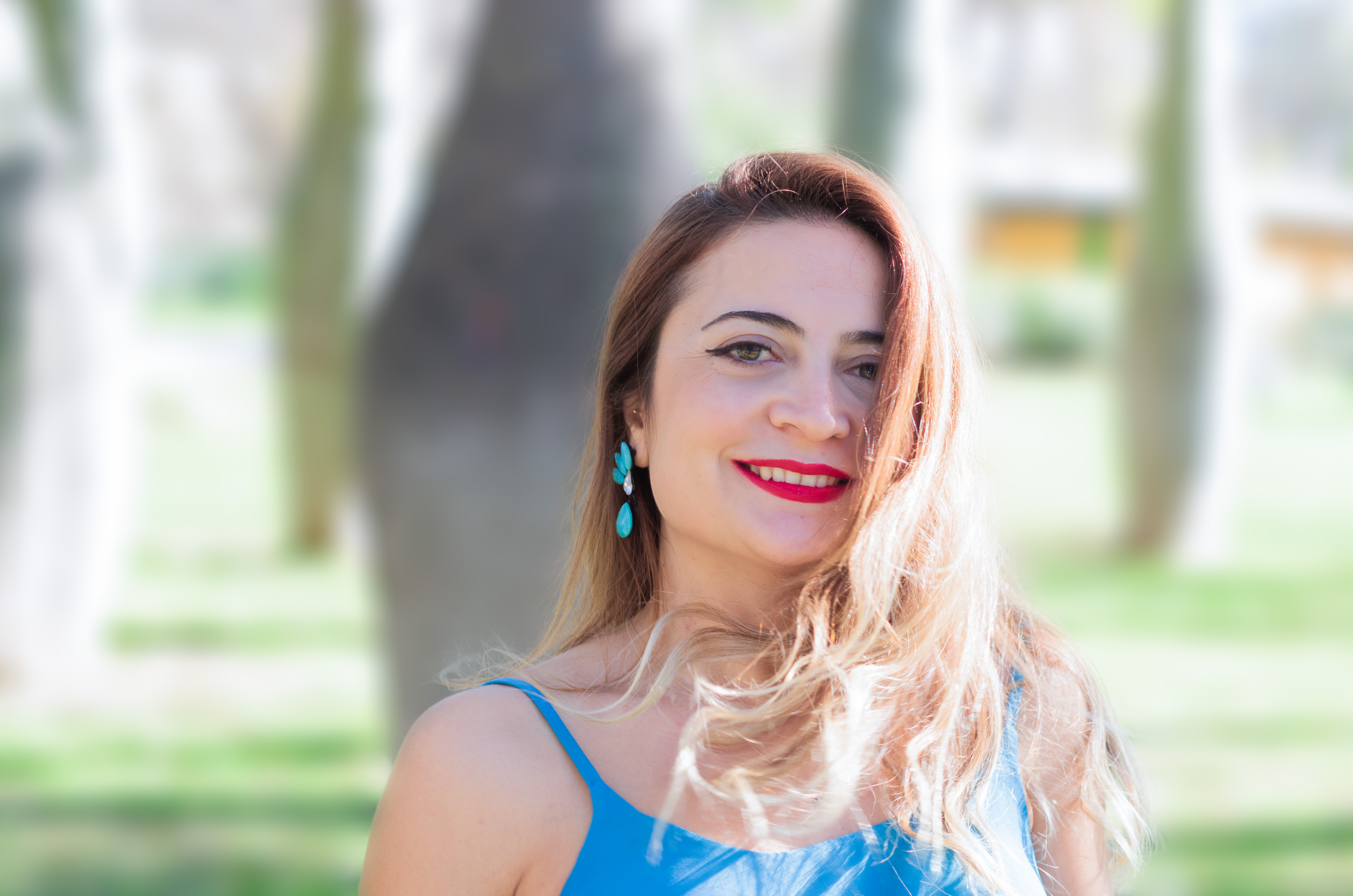 a portrait in the park with the sun highlighting the woman's hair