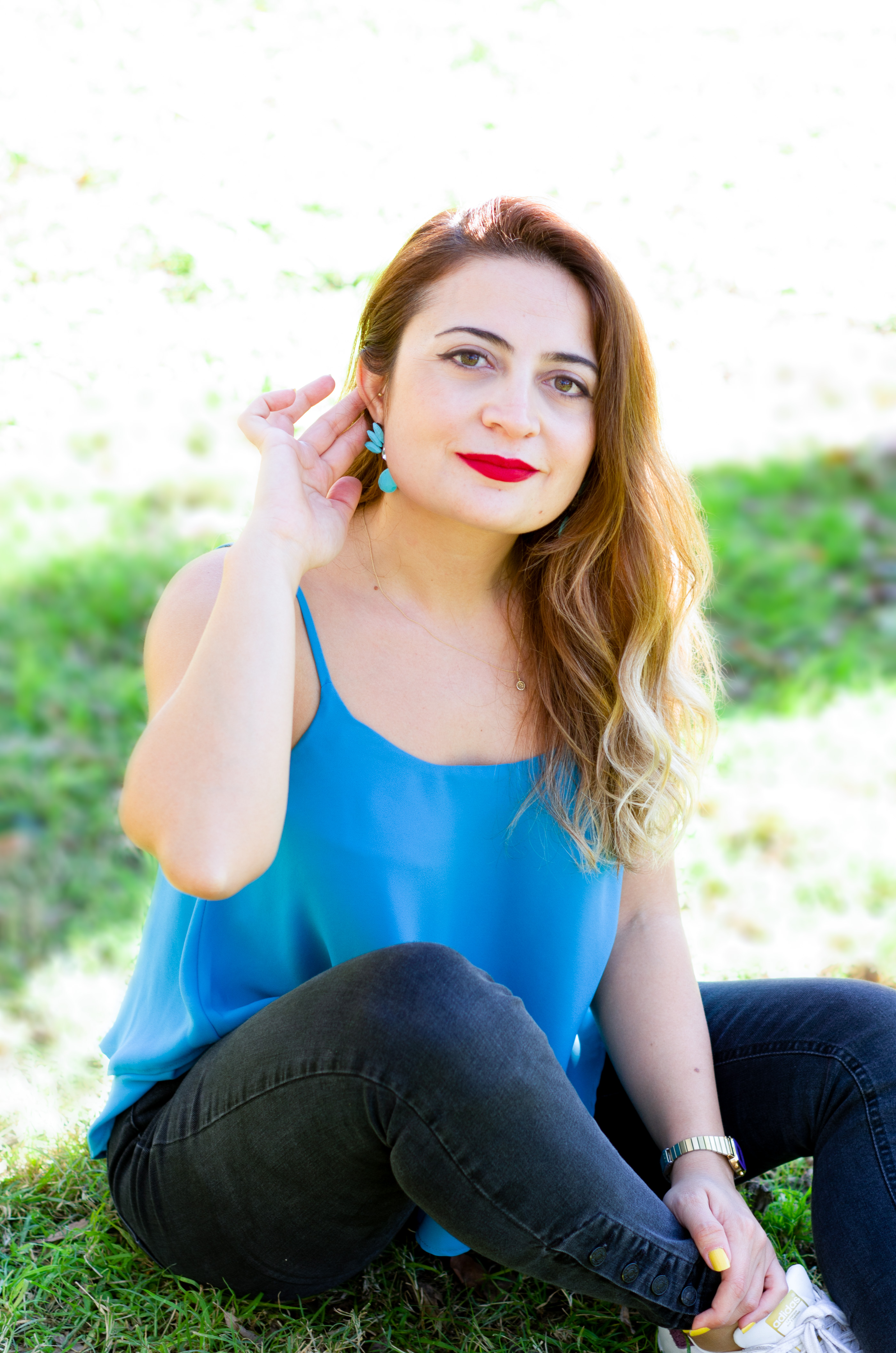 woman sitting on the grass in the park for a photoshoot