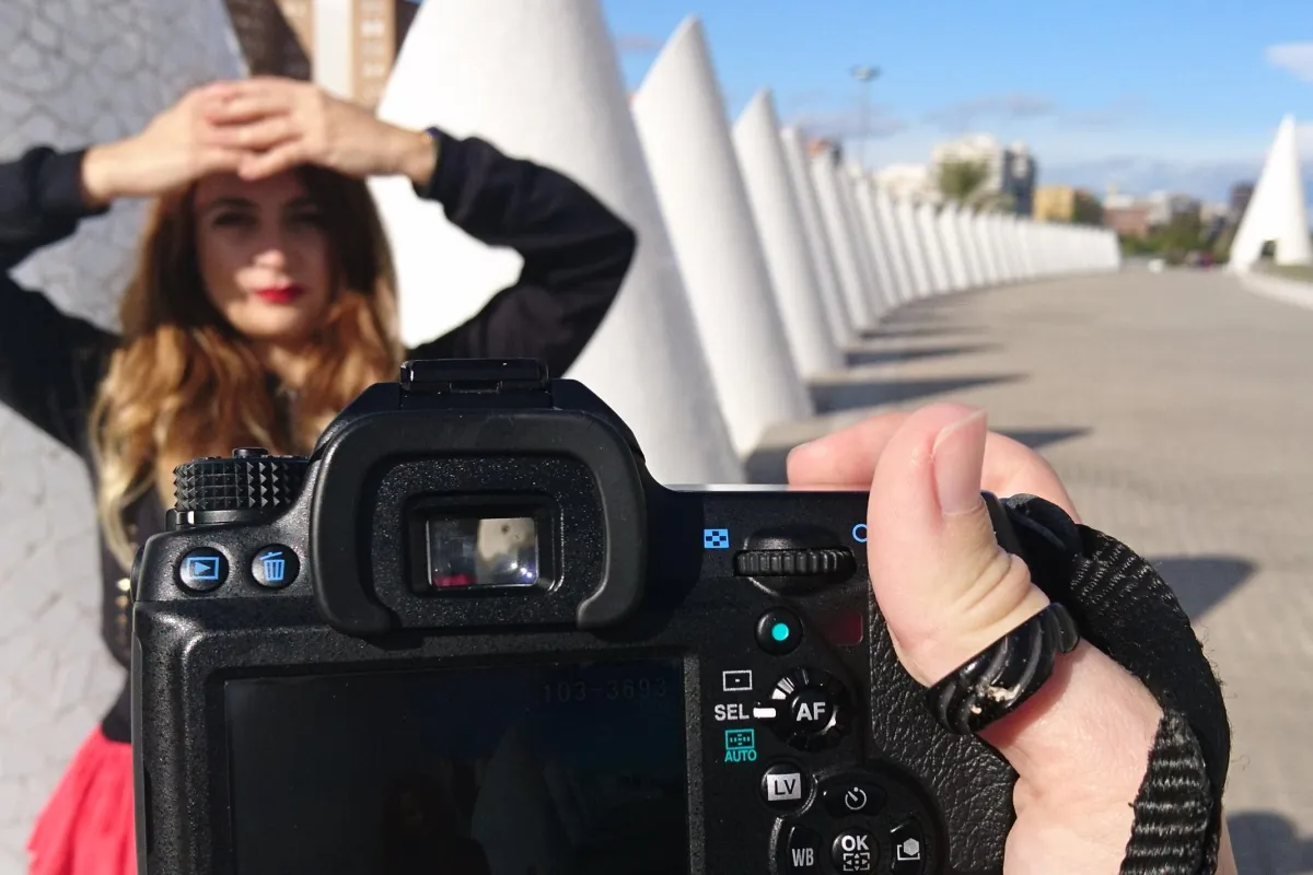 a model posing behind the camera at the city of arts
