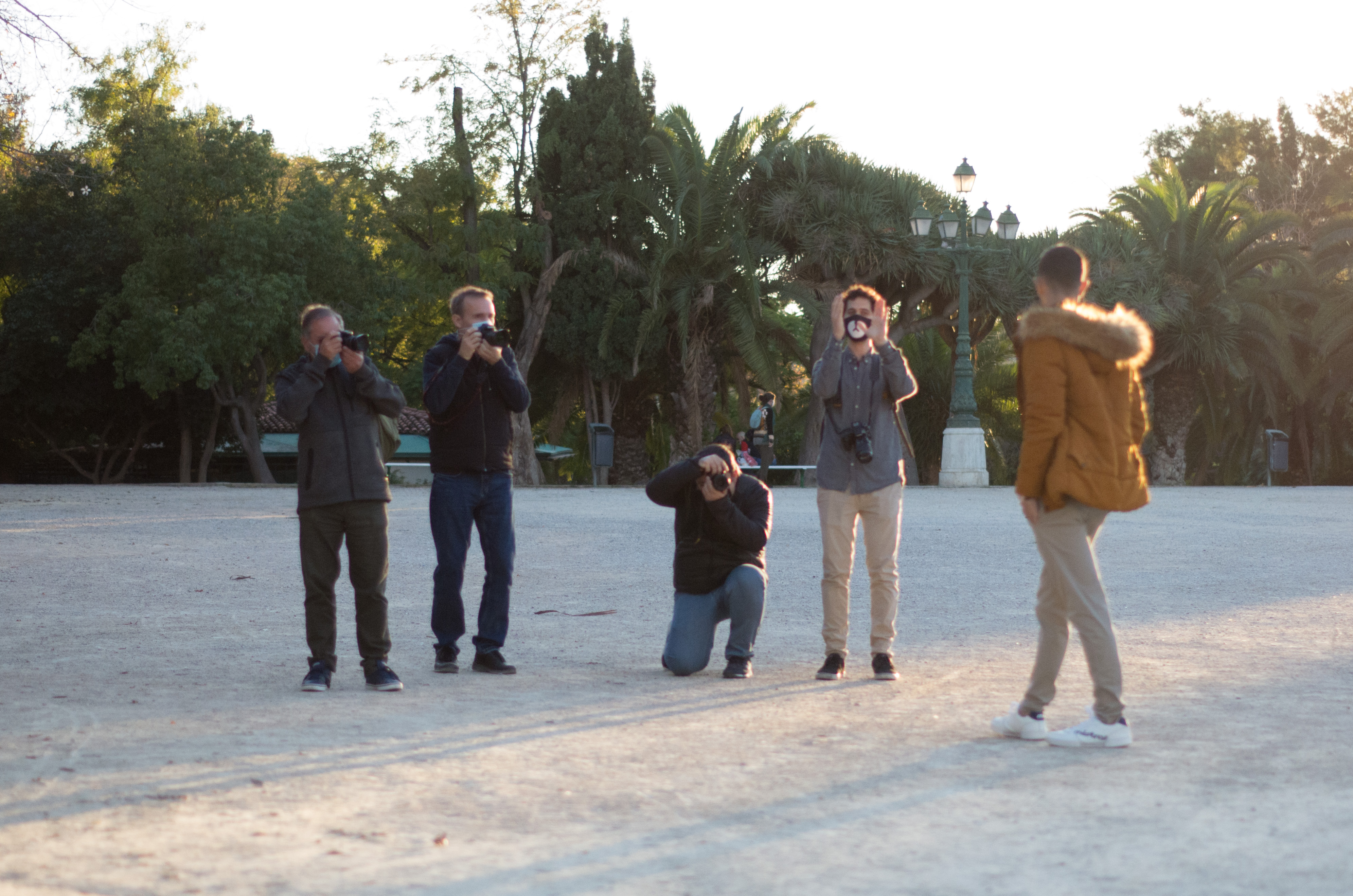A group of photographer at the Vivero's garden in Valencia taking photos of a model during a photo workshop