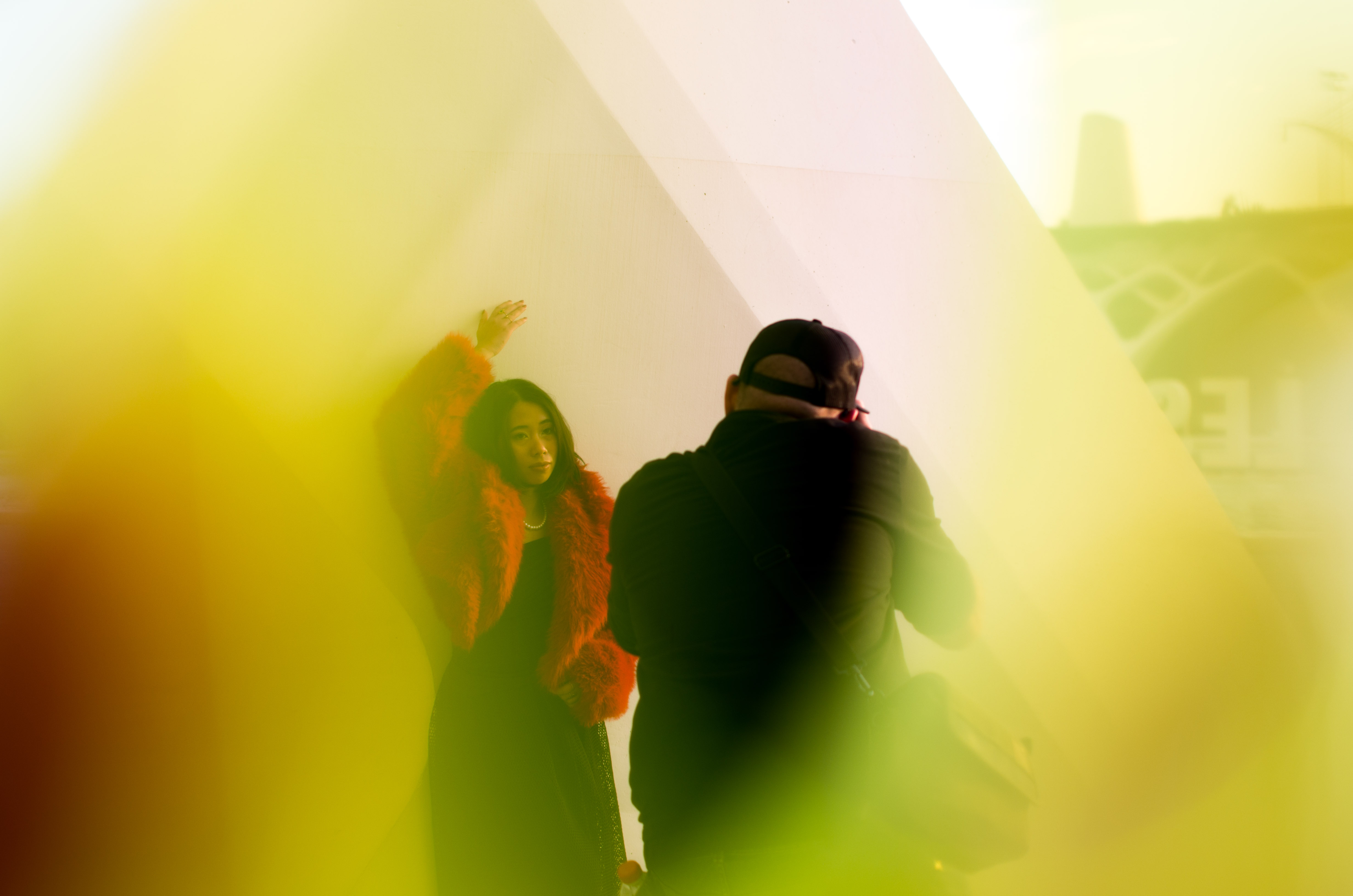 a photographer taking photos of a model at the city of arts with colored gels