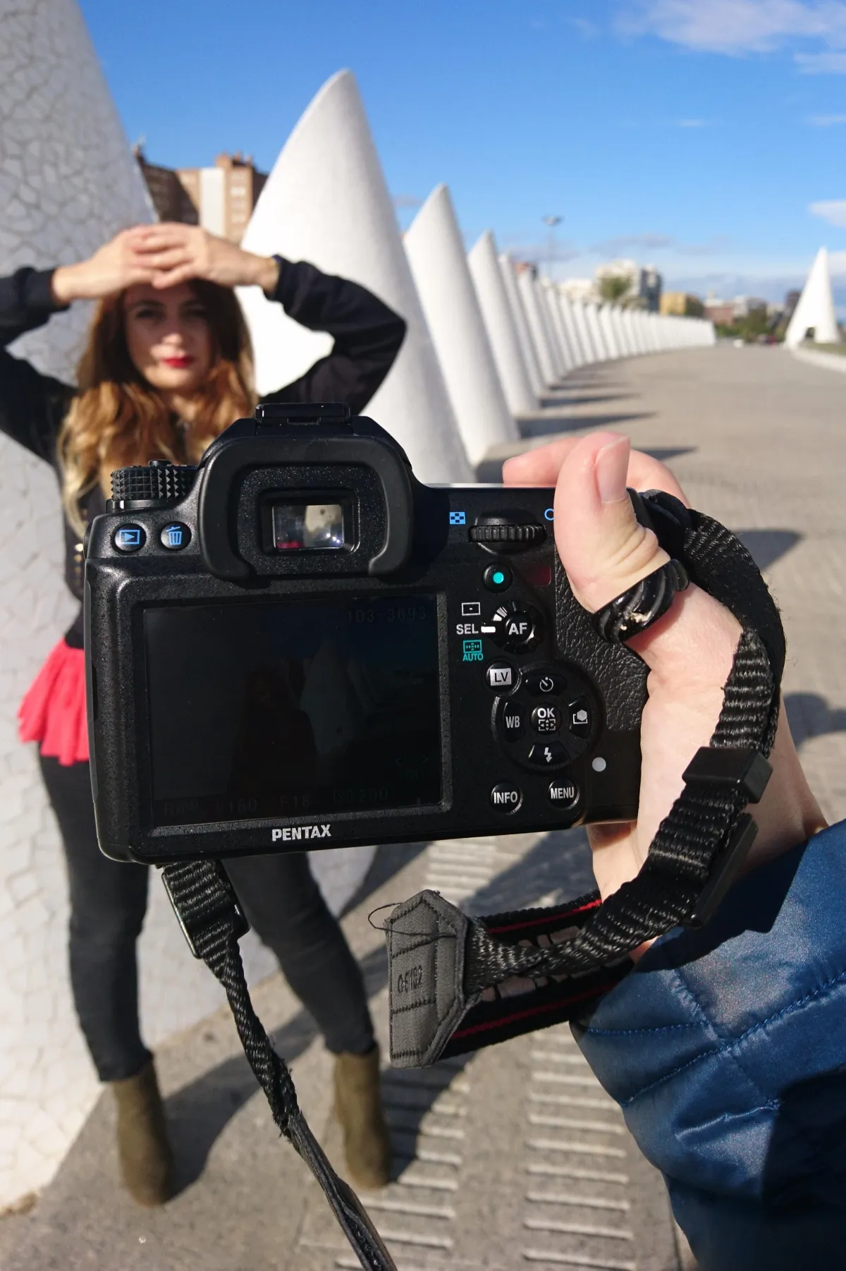 a woman taking a photo with her phone during a private photo walk in valencia