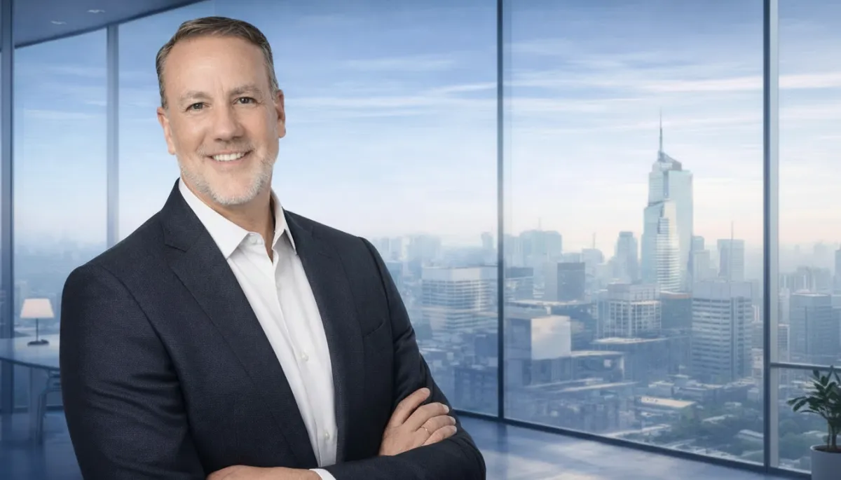 Portrait of business coach Avery Hale, mid-40s professional with warm friendly posture, studio-lit background with pale tones.