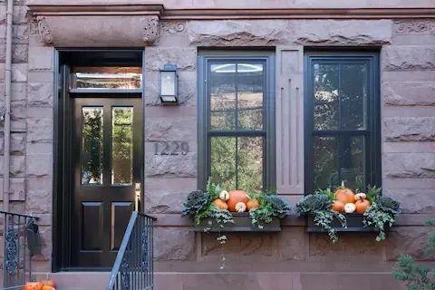 Brownstone facade with fall window boxes, a classic home for spray foam retrofits in Perth Amboy