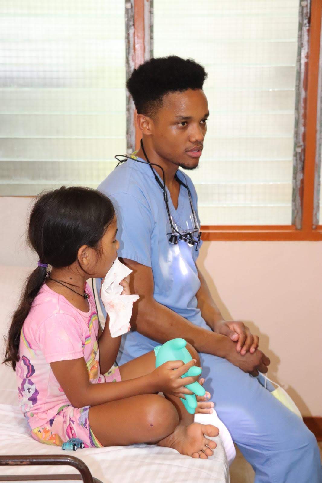 Dr. Wongk comforting a young patient after treatment