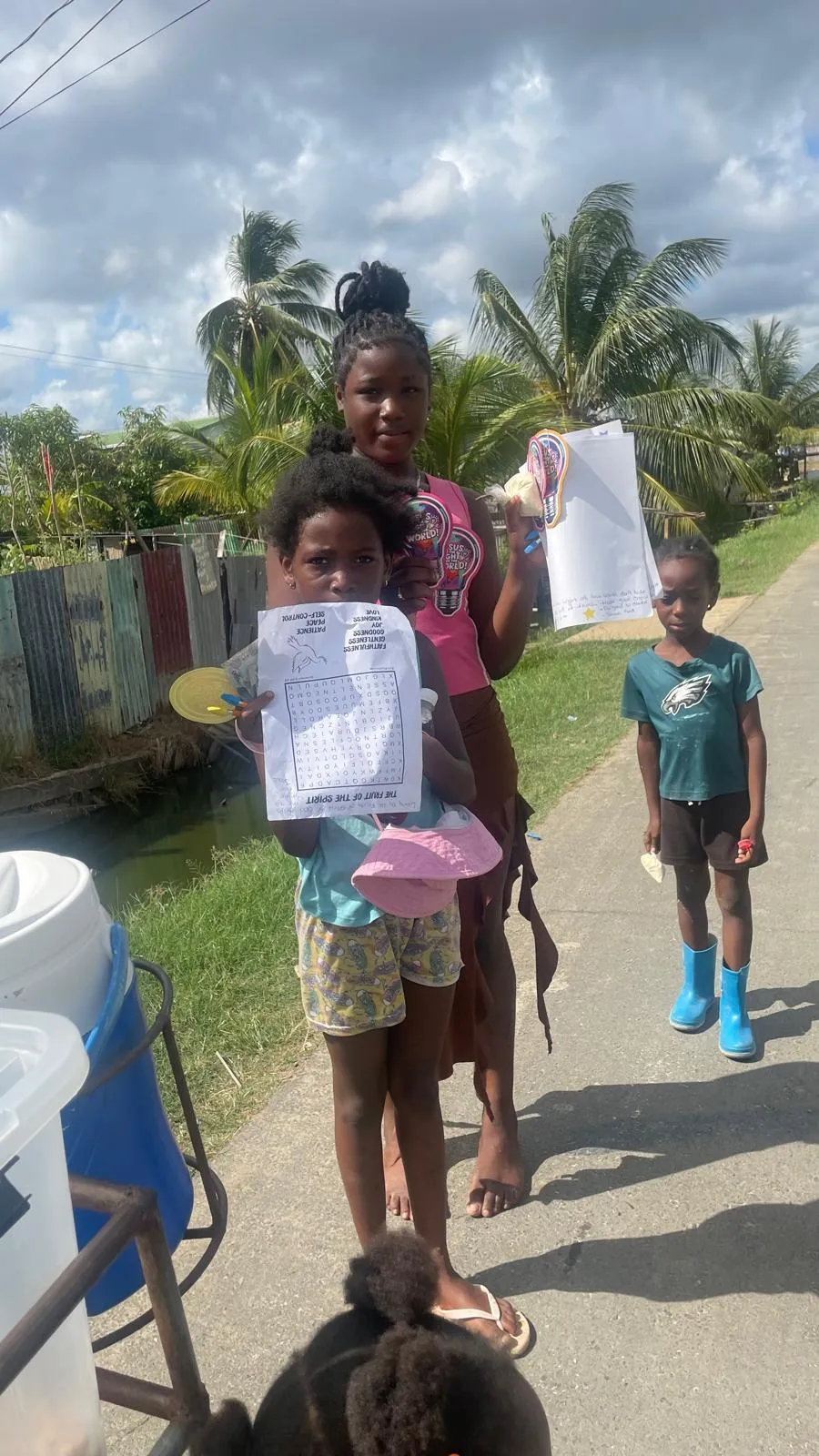 Girls holding Fruit of the Spirit activity sheets
