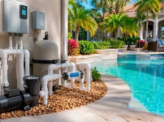 Pool equipment pad with sand filter, pump, and plumbing serviced by Lakeside Pool Service