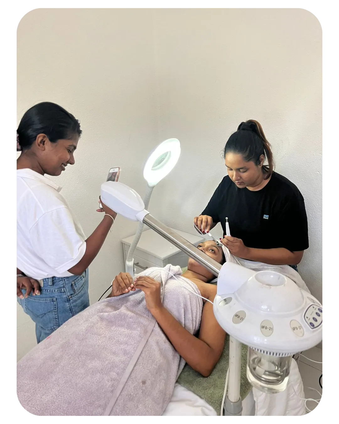 Miracles Academy student performing a facial on a client, showcasing practical training in beauty courses