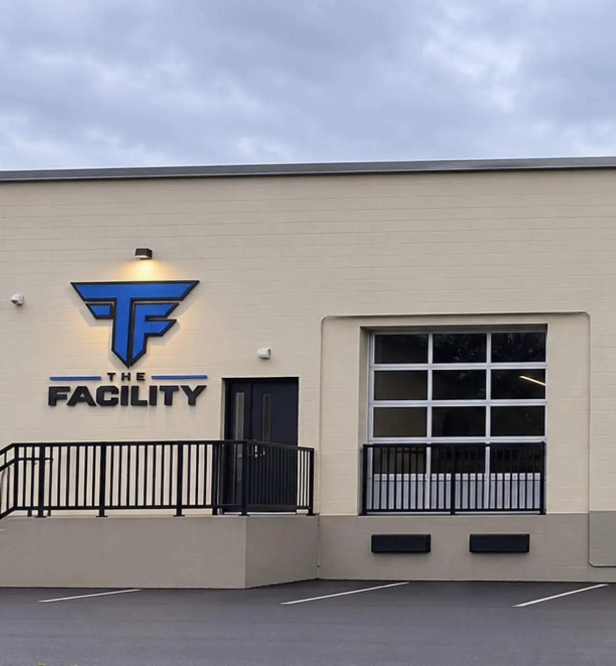 Athlete taking dynamic swings in high-tech indoor batting cage equipped with tracking sensors