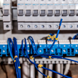 Commercial electrician servicing an electrical panel.
