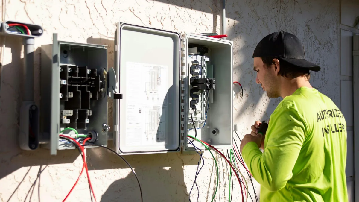 Electrician performing electrical code correction work