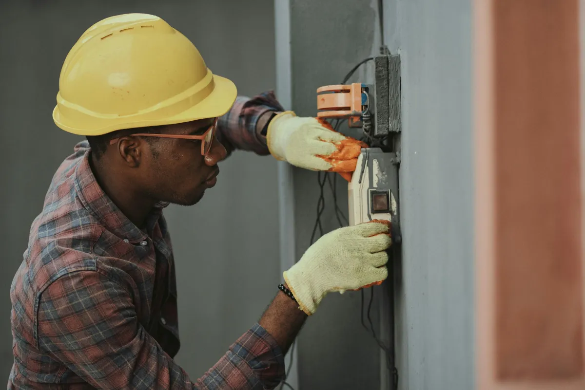 Electrician installing a new residential electrical panel.