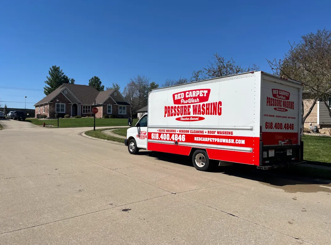 Red Carpet Pro Wash technician pressure washing a brick home in Troy, Illinois