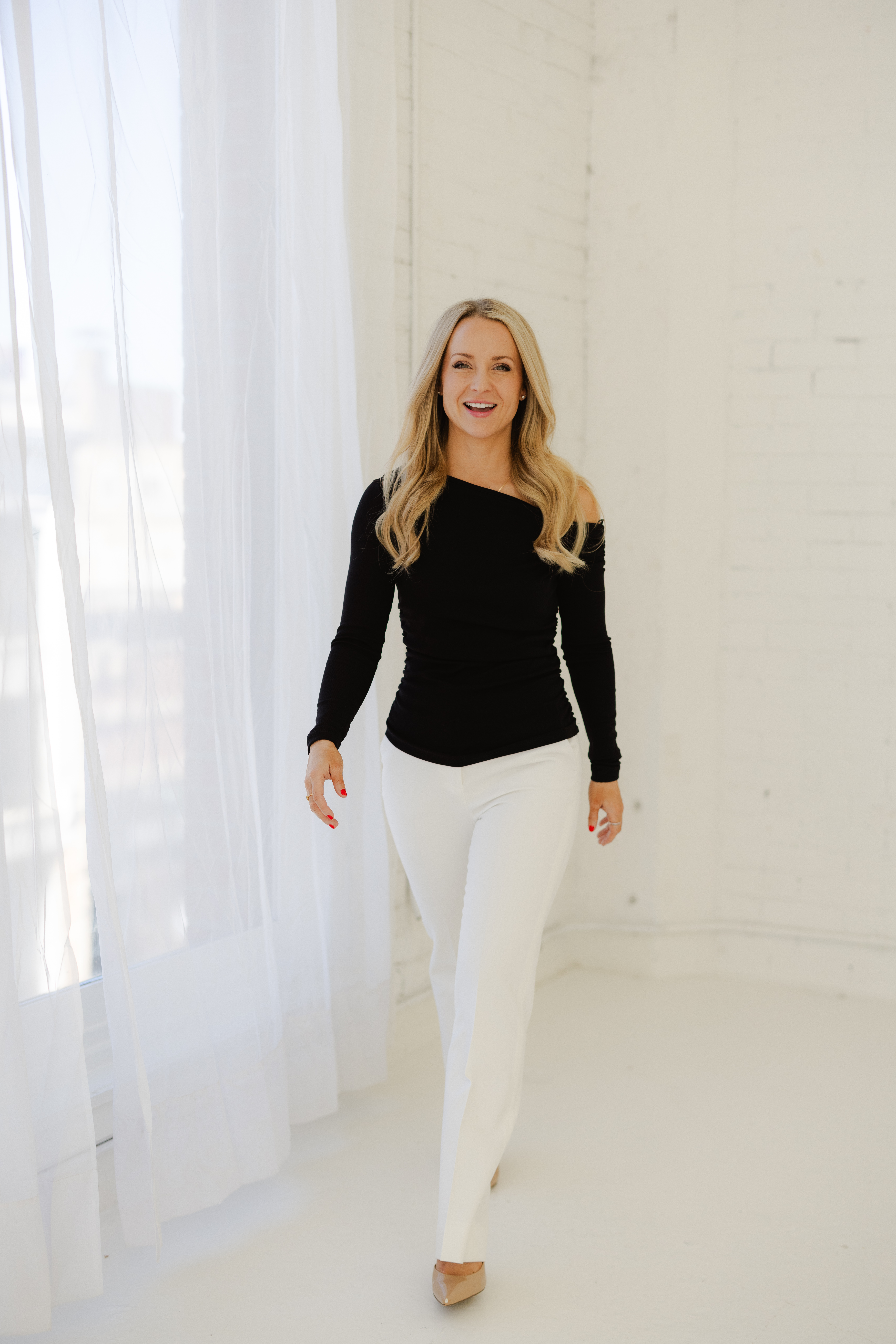 Photo of Dr Summer in Black Top and white pants
