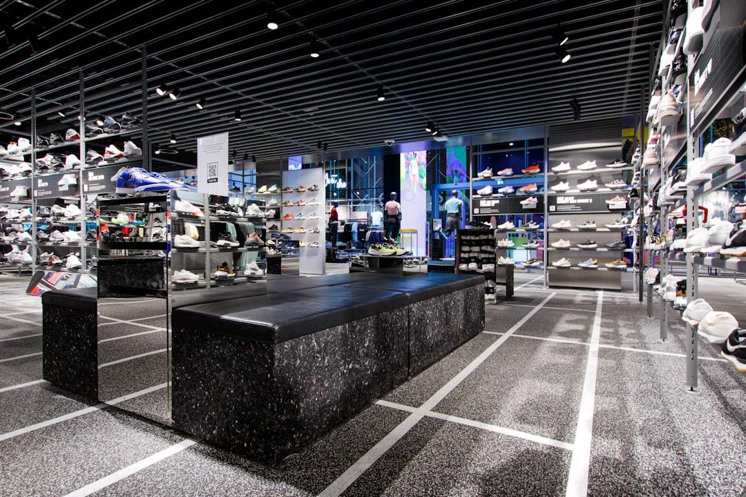 Interior of a modern, well-lit commercial retail space featuring organized shoe displays and industrial shelving, showcasing OneC Consulting’s commercial build-out capabilities.