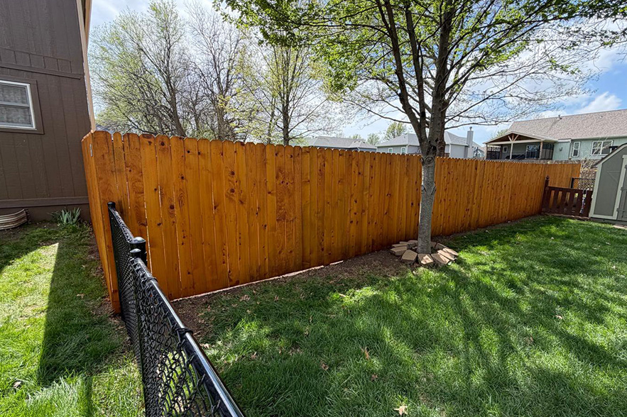 Freshly stained wood fence in Burleson, TX