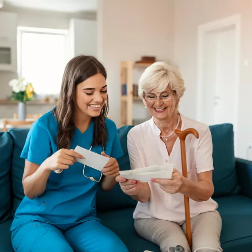 healthcare worker and elderly woman looking at paper