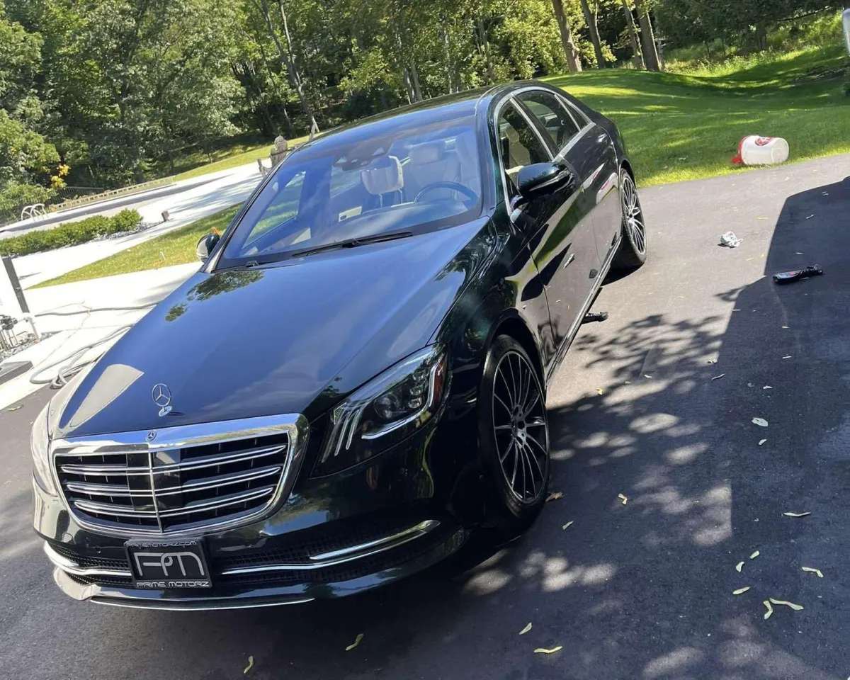 Black Mercedes parked in driveway after being detailed.