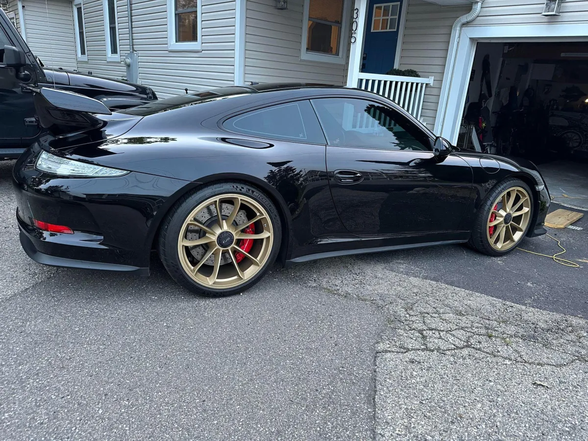 Black Porsche 911 sitting outside after being detailed.