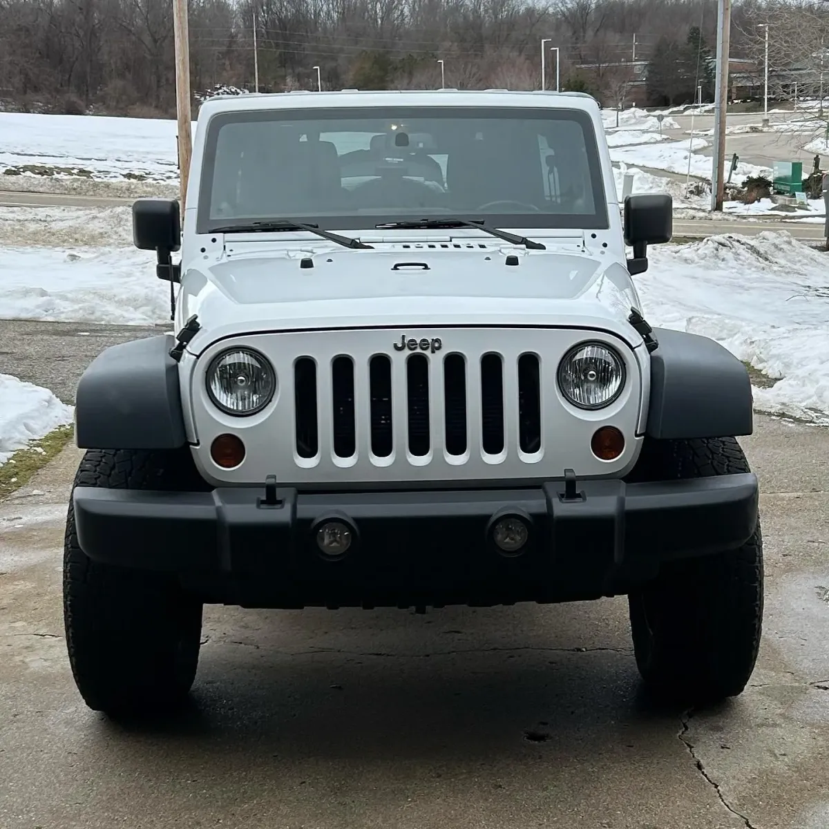 Jeep parked in a driveway after being detailed.