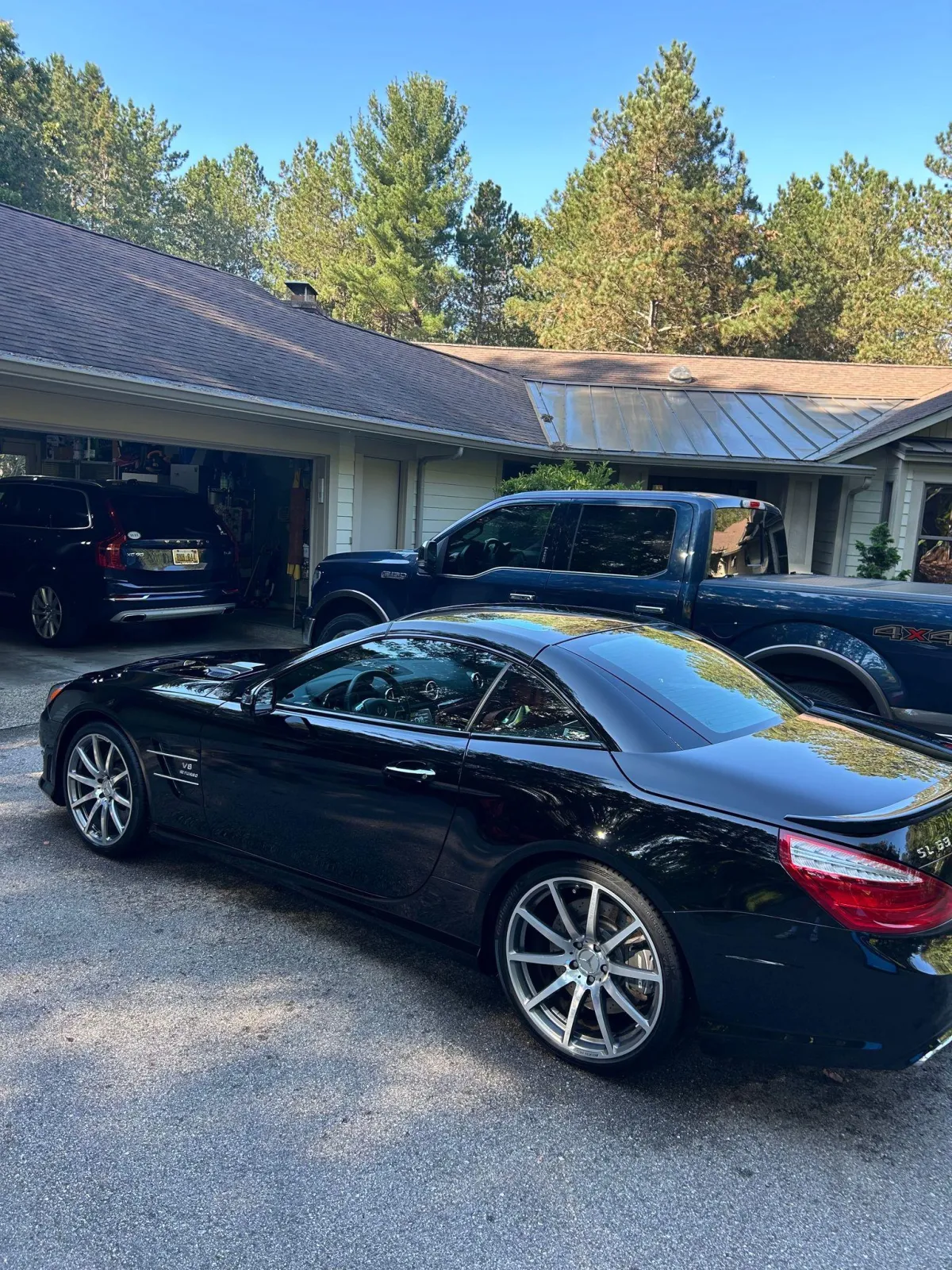 Shiny black car in garage with a ceramic coating applied.