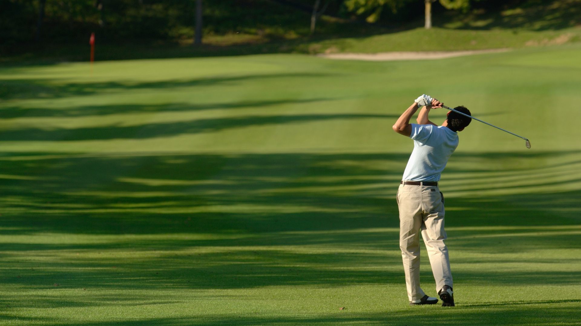 Active man golfing during summer while supporting nervous system function
