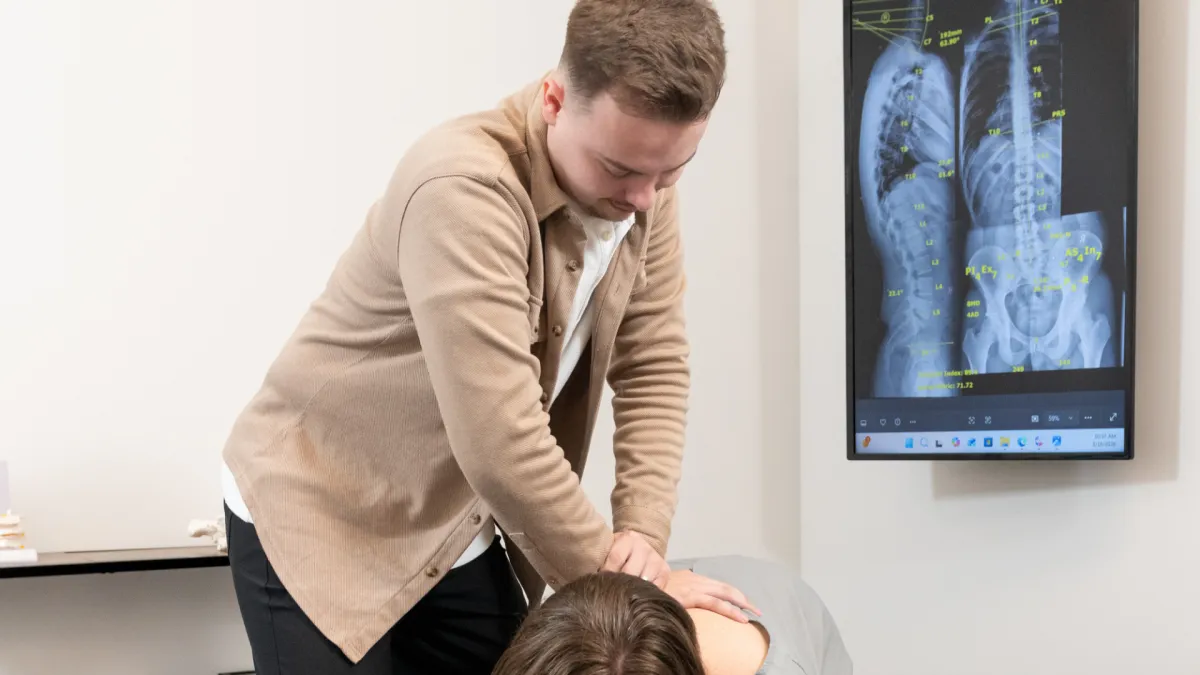 Dr. Kaiden adjusting patient with Gonstead chiropractic care at Rise Family Chiropractic in O'Fallon, Missouri.
