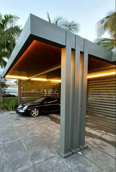 beautiful pergola that is bronzes with a luxury sports car beneath it. 