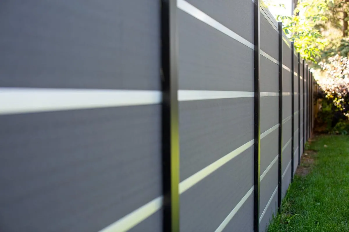 Picture of A Greenwood Fence Composite fence that has black aluminum post and gray slates. 