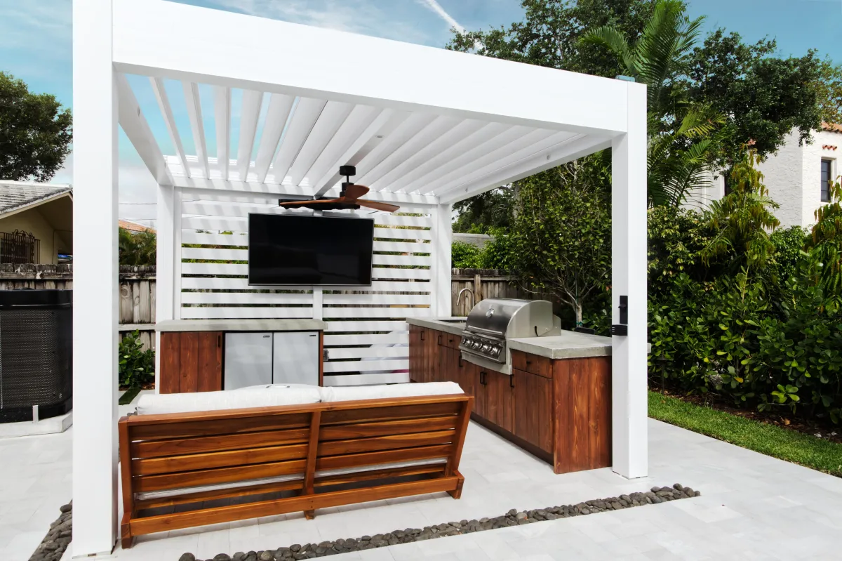 A photo of a home with Defender Motorized Screens half open.  The sky is ominous gray. 