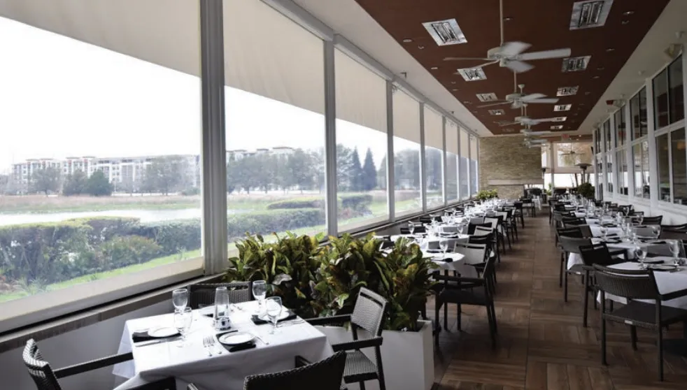 A two story building with motorized screens provided sun protections and energy savings