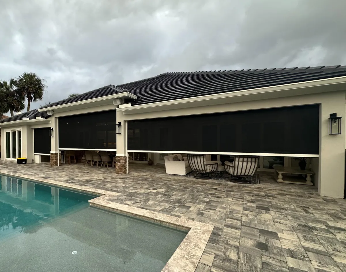 Motorized hurricane screens lowered on a Florida home in Palm Coast, installed by Florida Living Outdoor