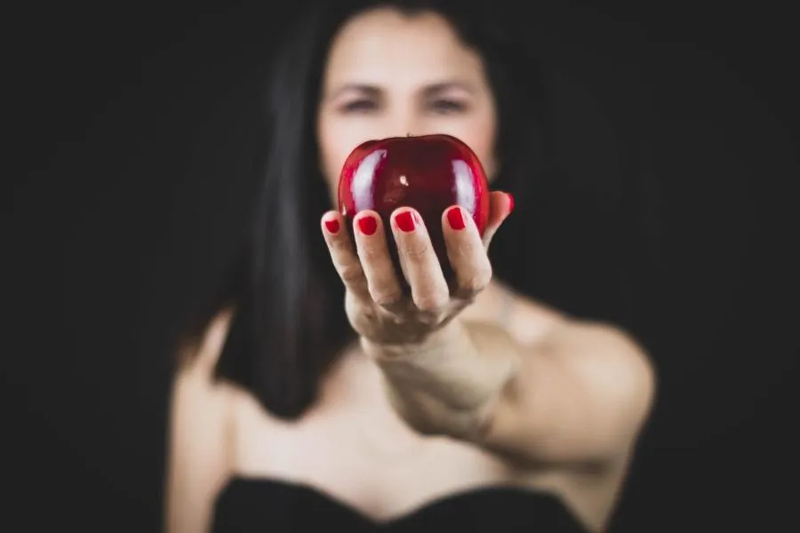 woman holding apple