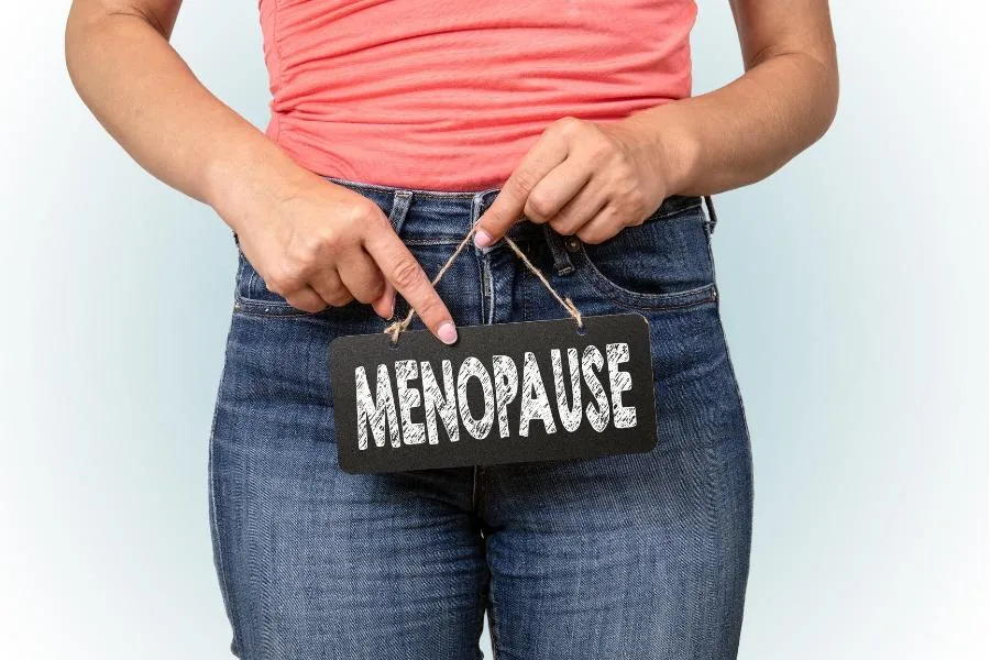 woman holding menopause sign