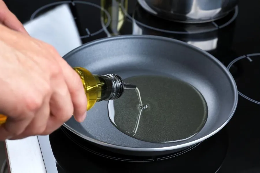 pouring oil in a pan